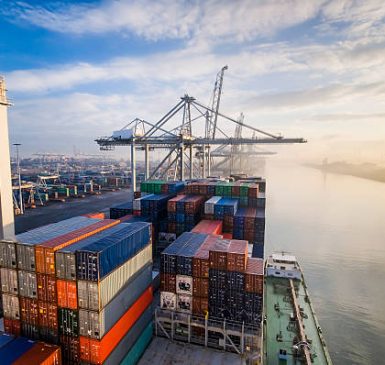 Sunrise in busy container terminal in Rotterdam, Netherlands.